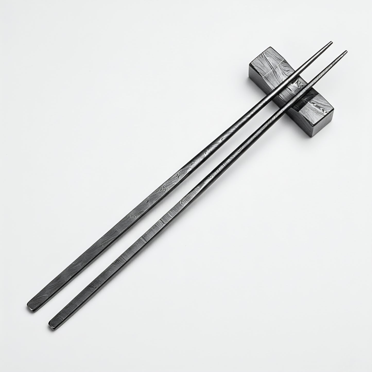 Black chopsticks with wooden ends on a white background