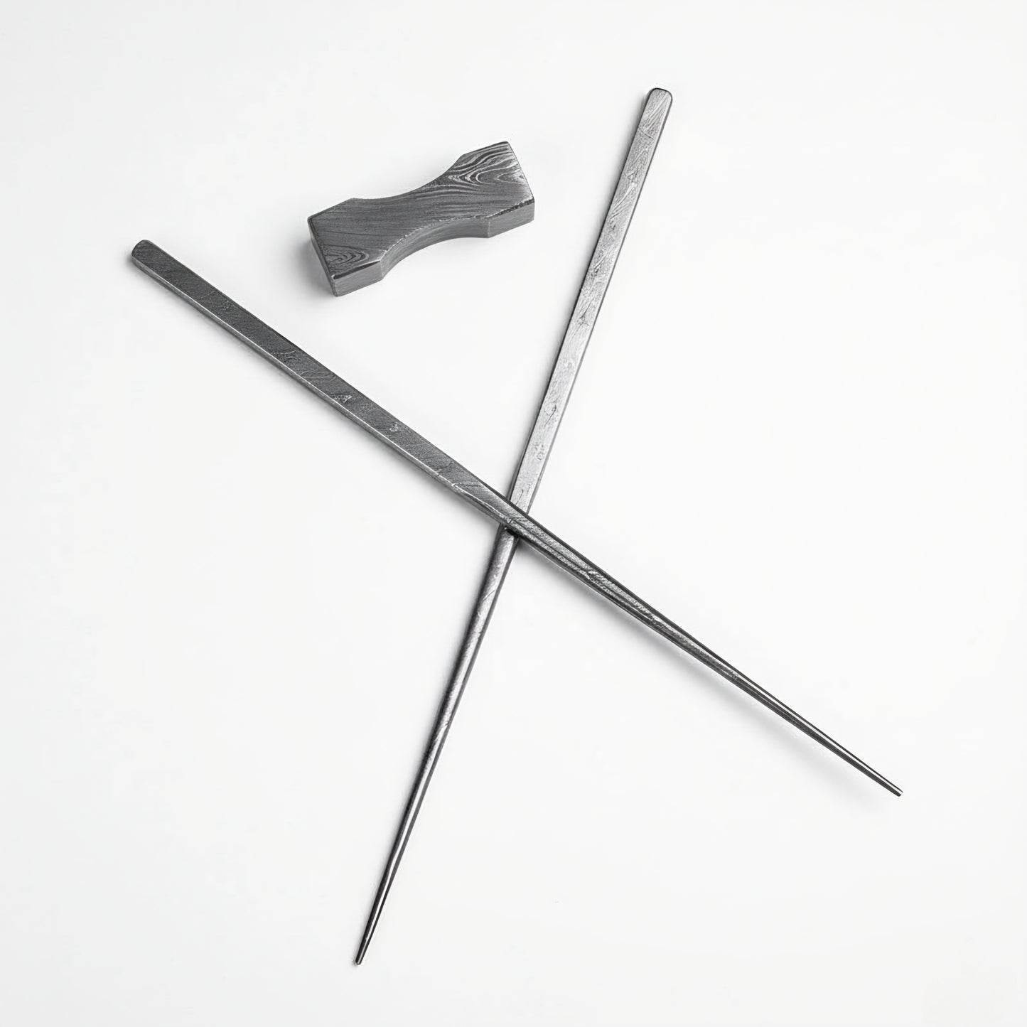 Two metal rods crossed on a white background
