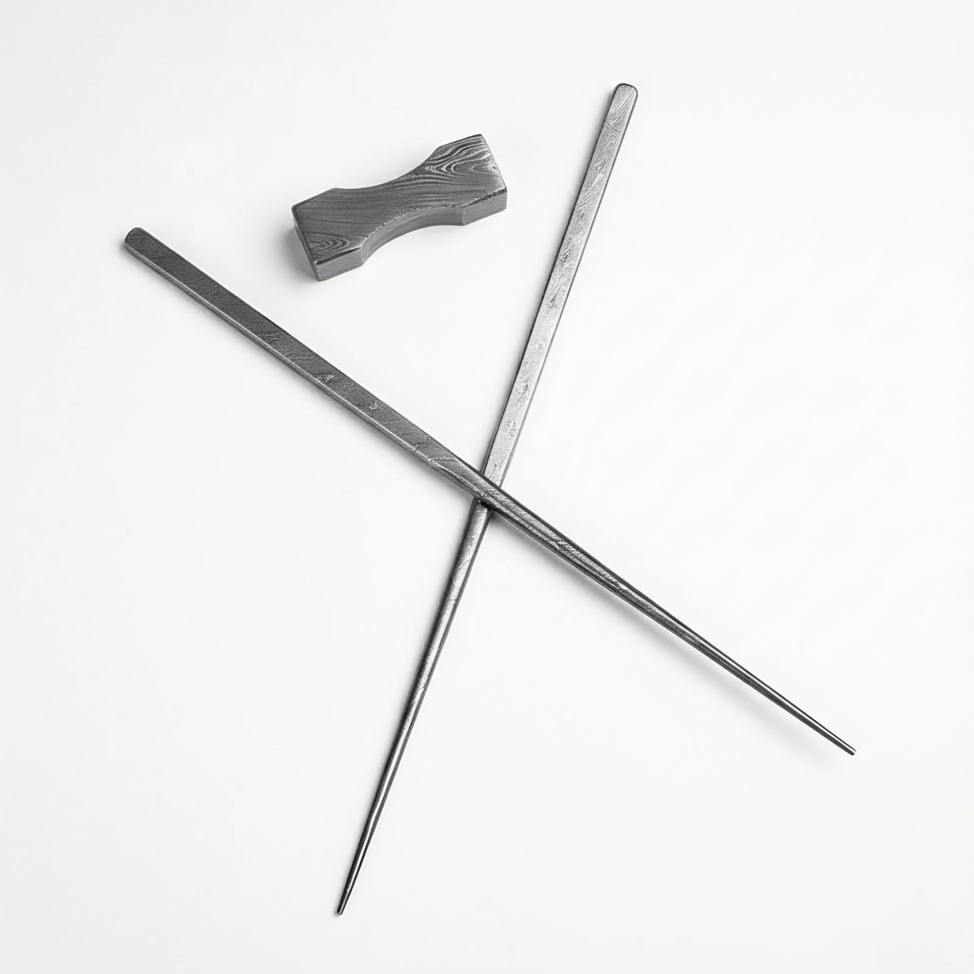 Two metal rods crossed on a white background