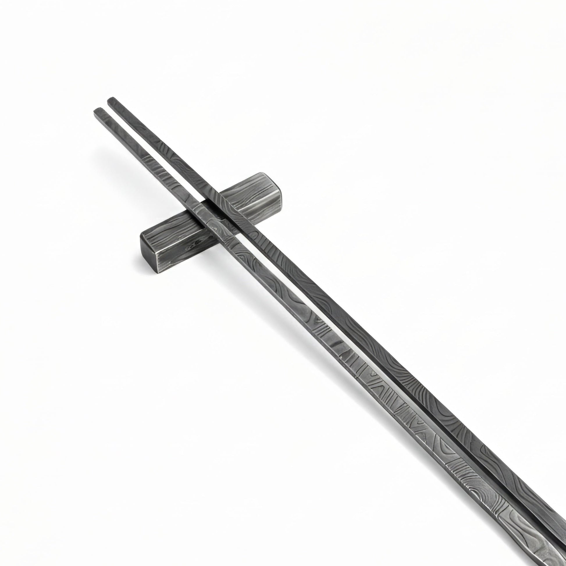 Black metal sticks with textured blade on a white background