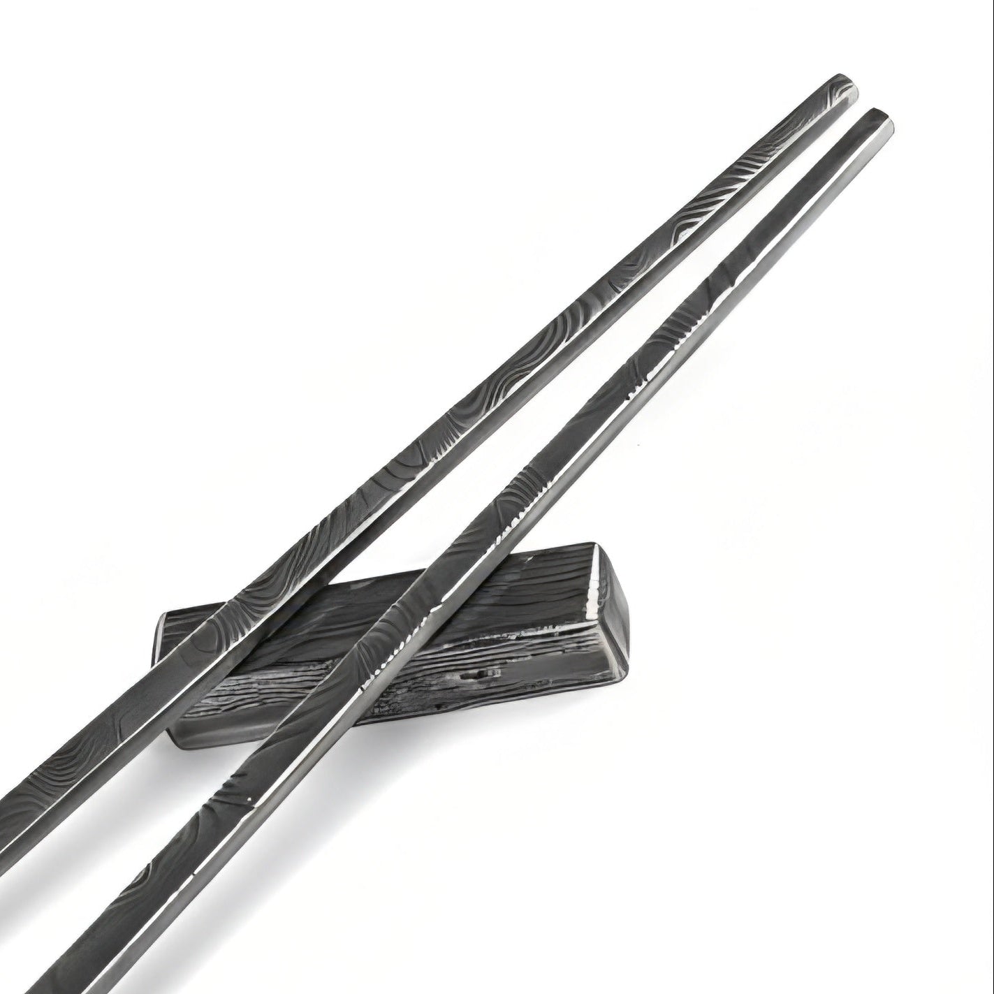 Pair of black metal chopsticks on a white background