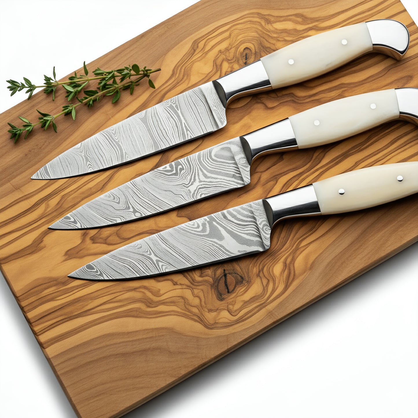 Set of four knives with white handles on a wooden cutting board.