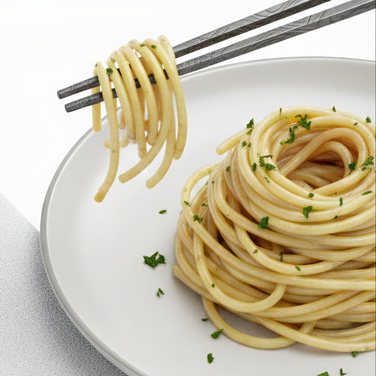 Spaghetti on a white plate with a fork twirling some above the plate.