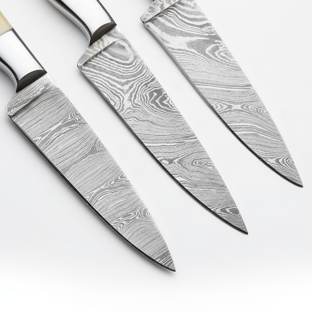 Three damascus steel knives on a white background