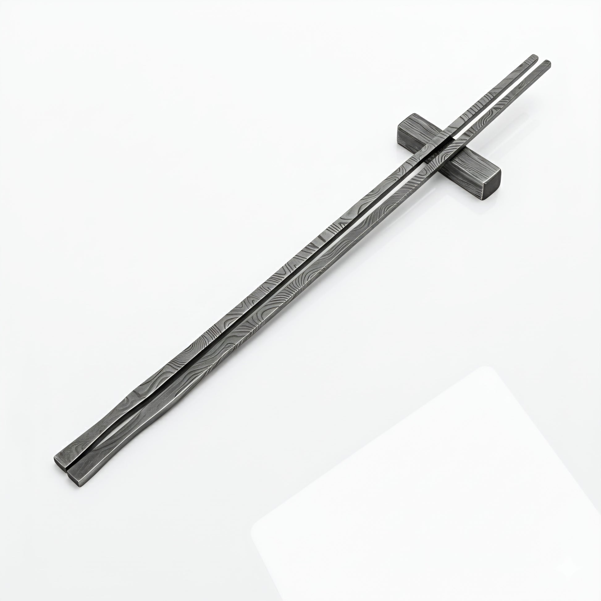 Pair of black metal chopsticks on a white background