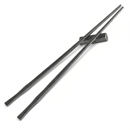Pair of black metal chopsticks on a white background