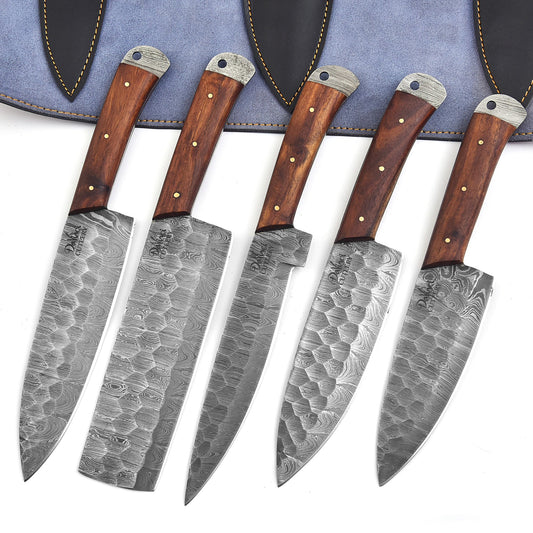 Set of five knives with wooden handles and damascus steel blades on a white background.