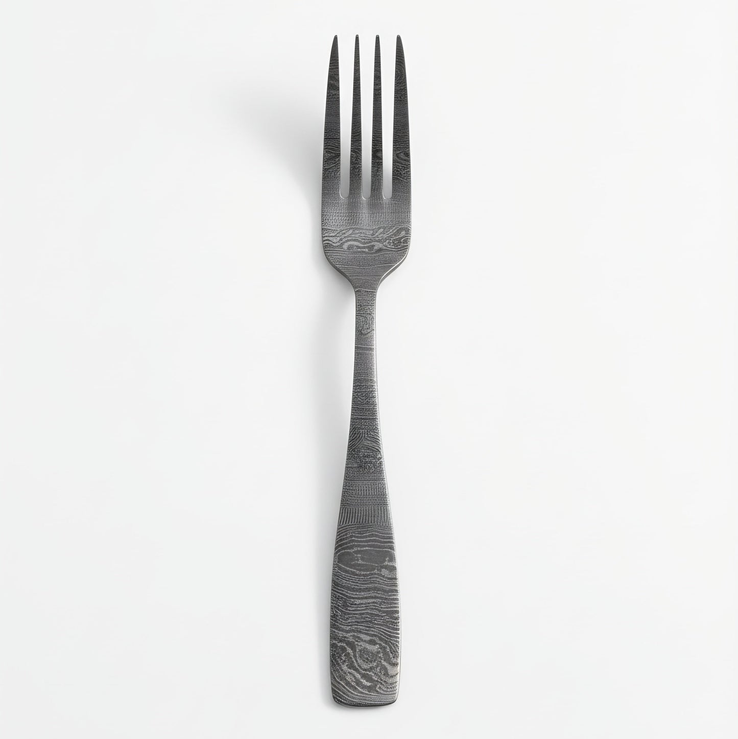 Stainless steel fork with textured handle on a white background Damascus cutlery set