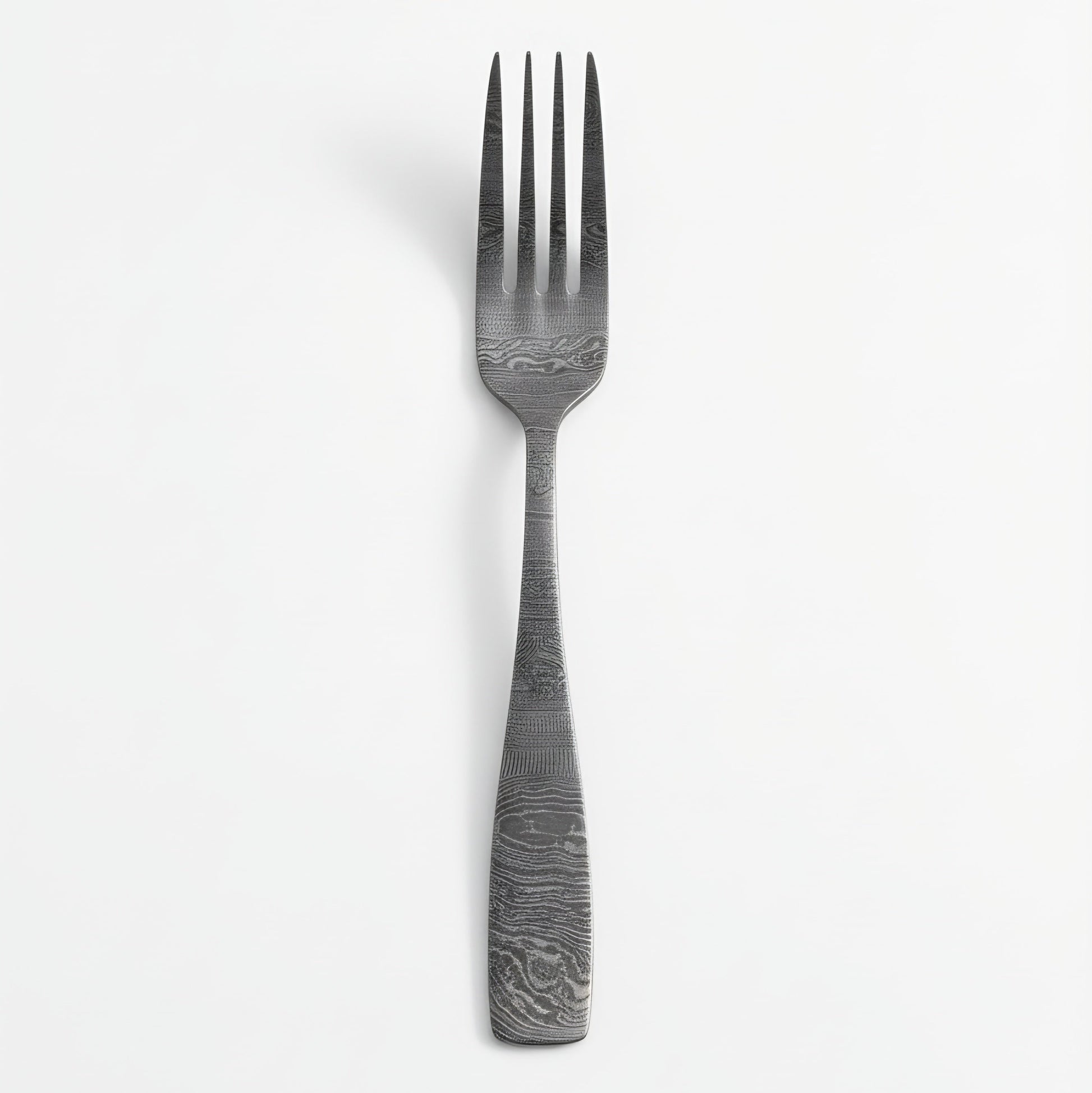 Stainless steel fork with textured handle on a white background Damascus cutlery set