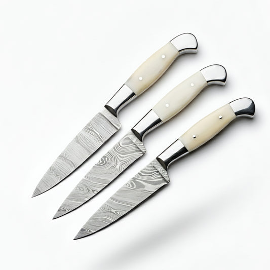 Three knives with white handles on a white background