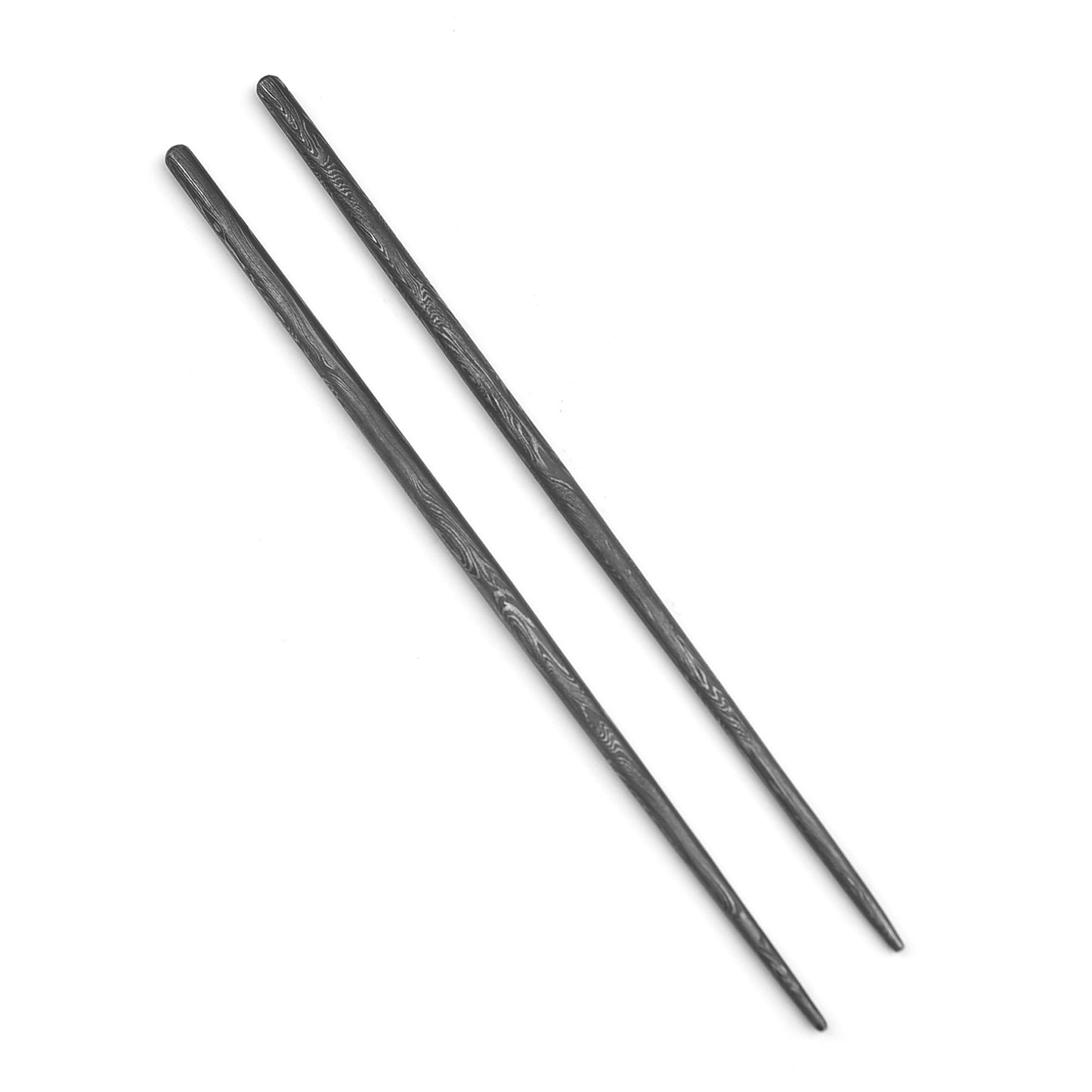 Two black chopsticks on a white background